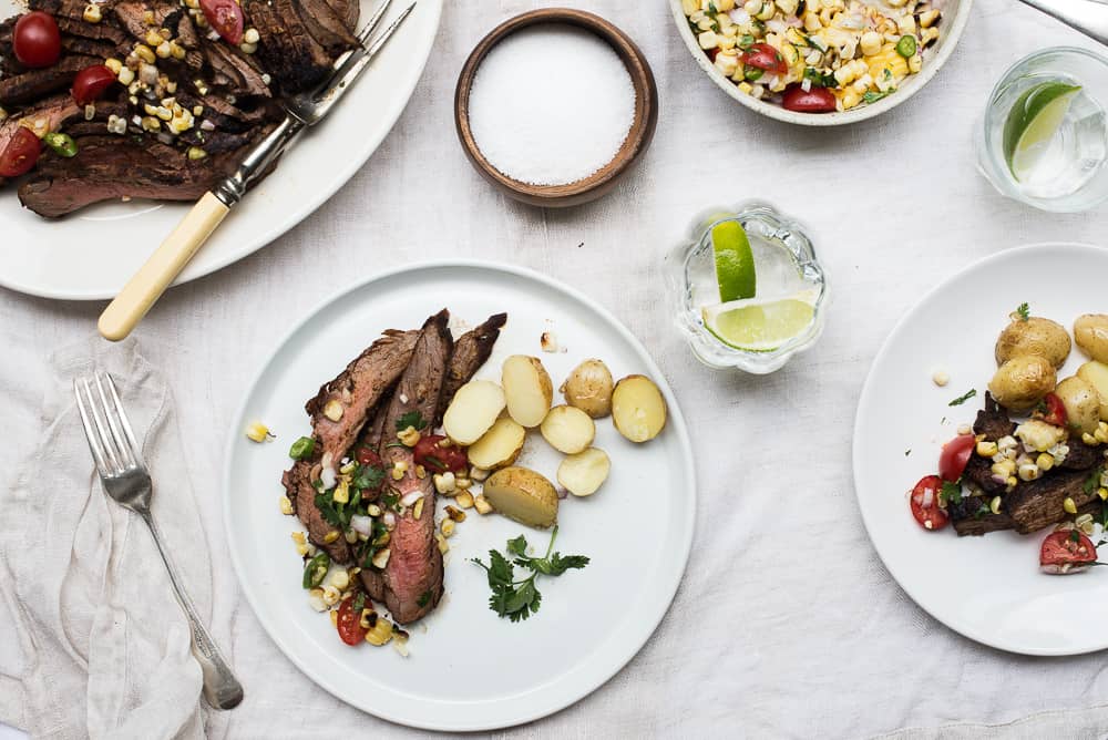 Flank steak with corn salsa at the table