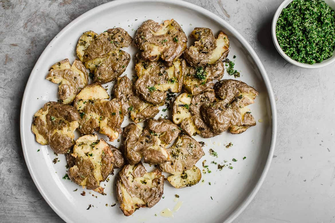 Smashed potatoes with herb salt on plate