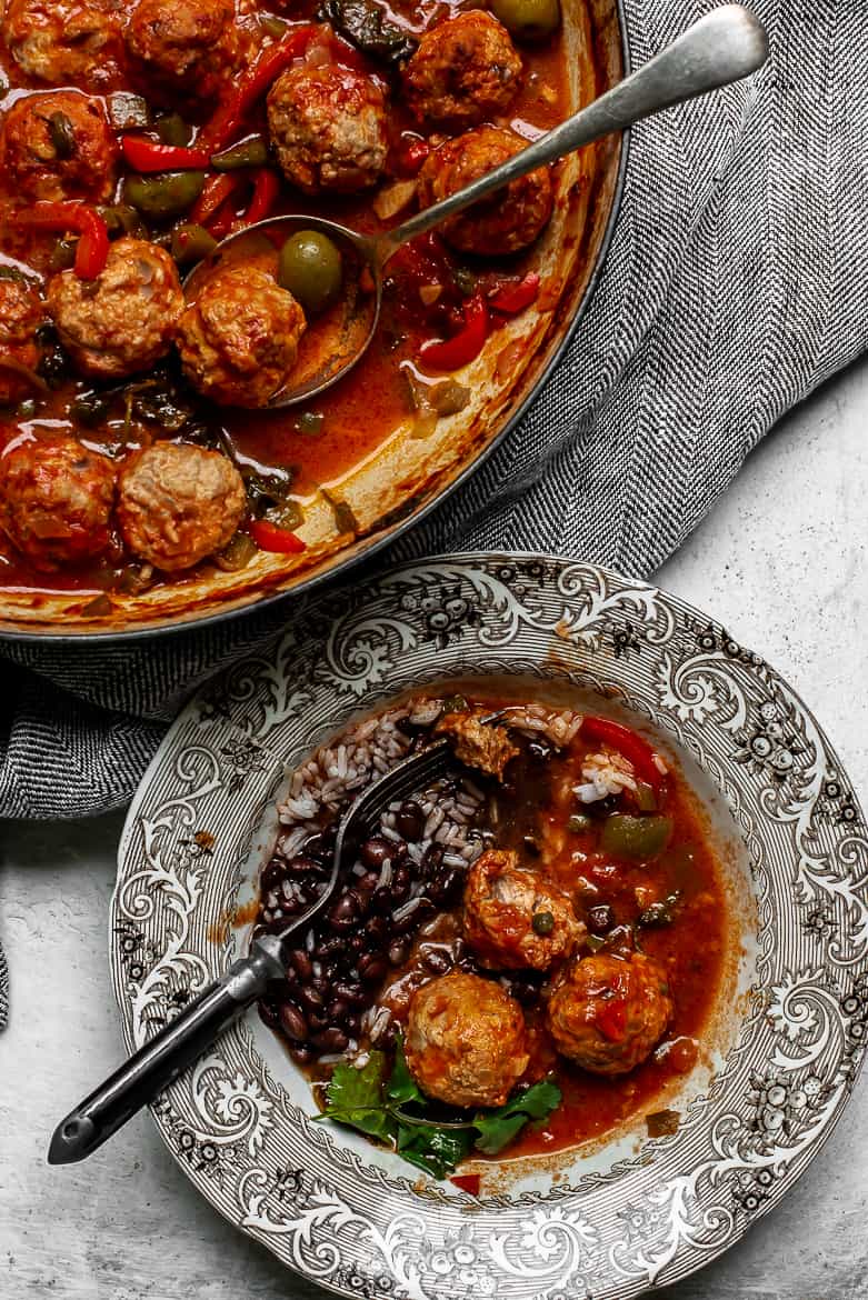 Stewed meatballs served with rice and beans