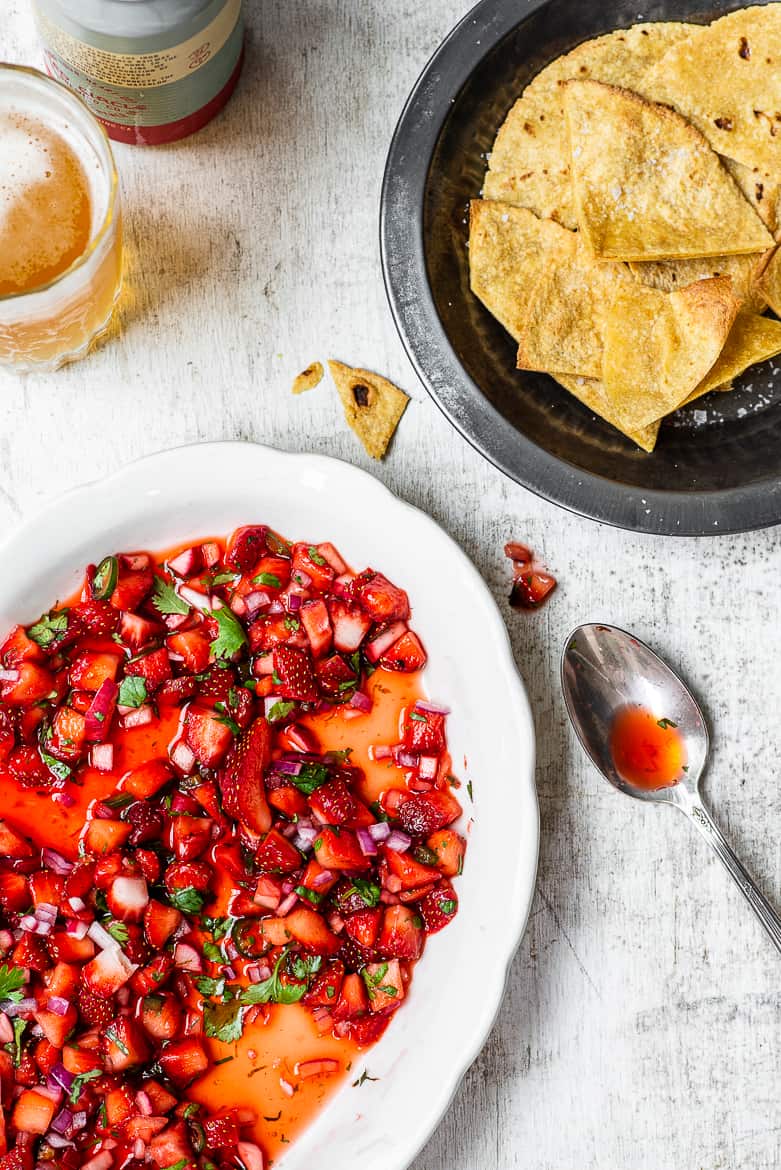 Fresh Strawberry Salsa on a platter/bowl with tortilla chips and beer