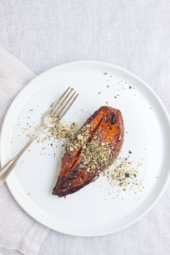 Plated Roasted Sweet Potato with Pepitas and hazelnuts.