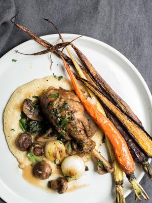 Coq au vin served with polenta and roasted veggies