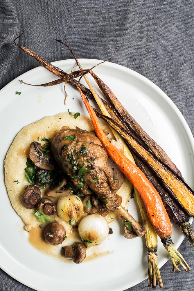 Coq au vin served with polenta and roasted veggies