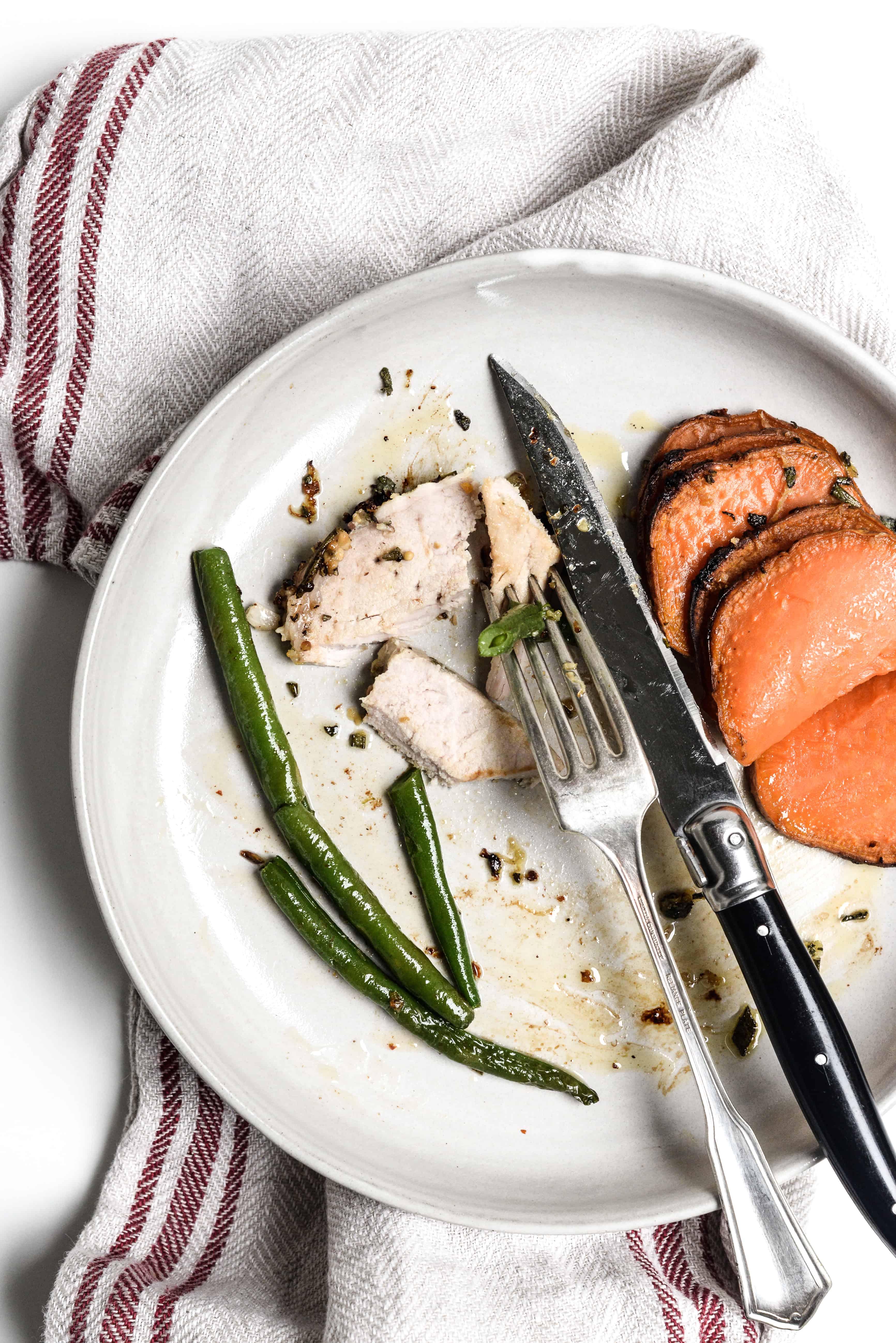 Hasselback Sweet Potato and pork on plate