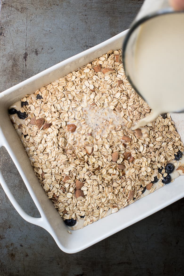 pouring milk into oatmeal/berry mix