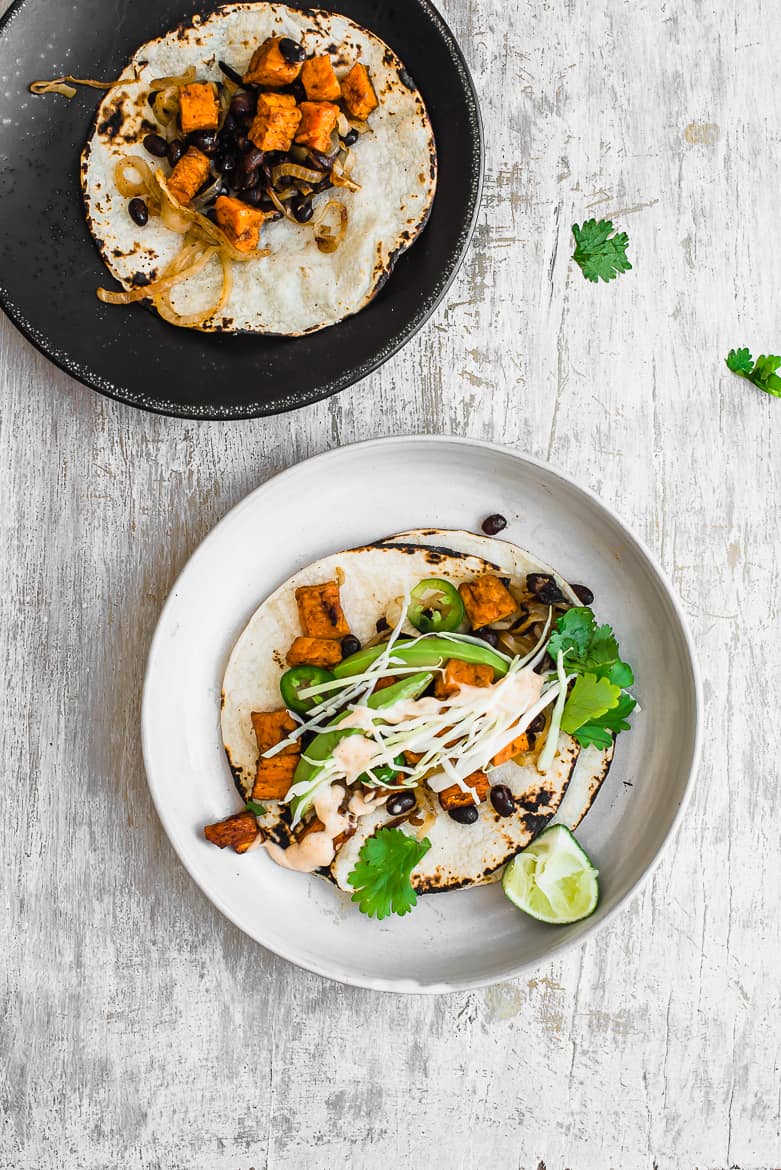 Sweet Potato Tacos with black beans on black plate