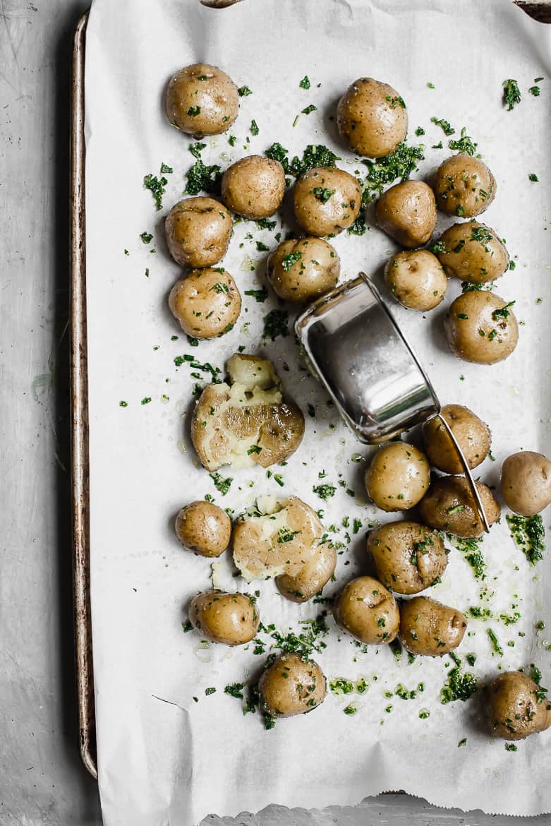 Boiled new potatoes being smashed