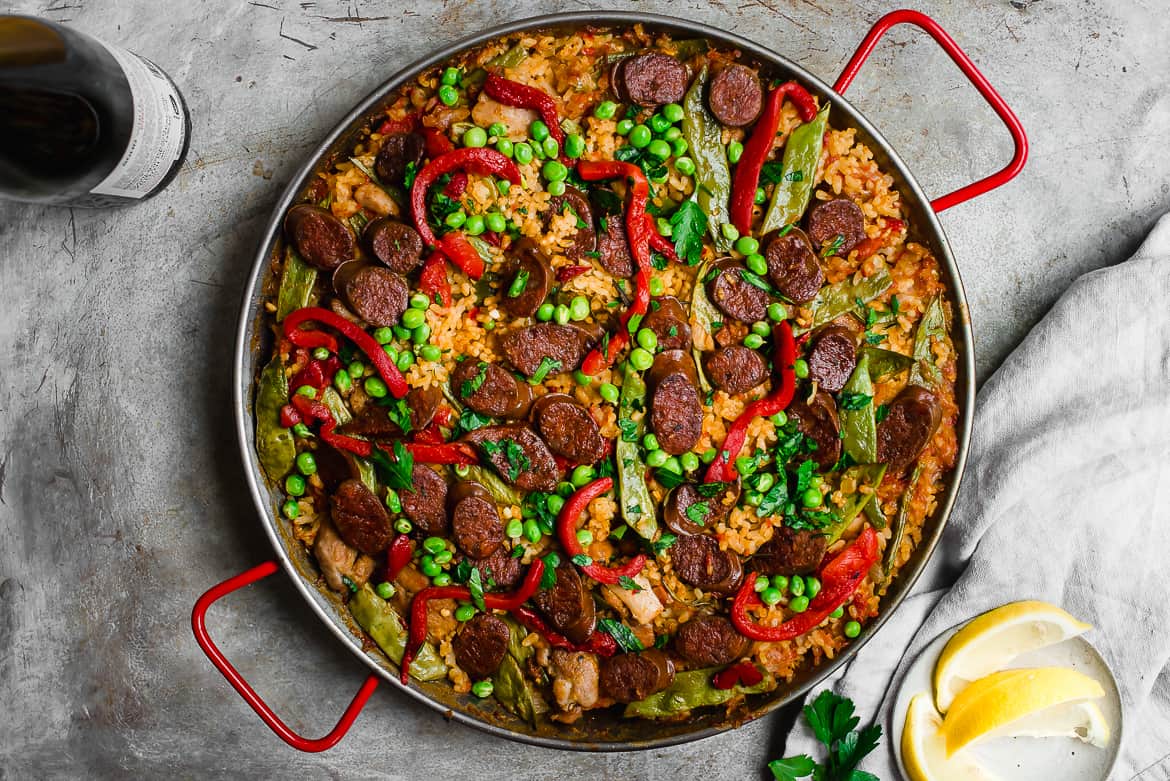 chicken and chorizo Paella with lemon wedges