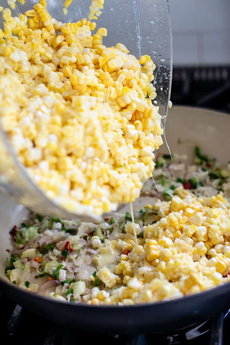 adding corn kernels to pan