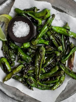 Blistered Shishito peppers with flaky salt and limes