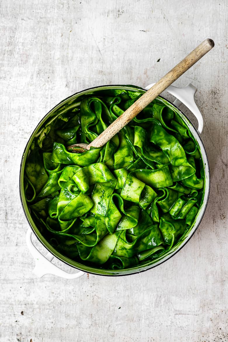 Pappardelle pasta in pot with kale sauce