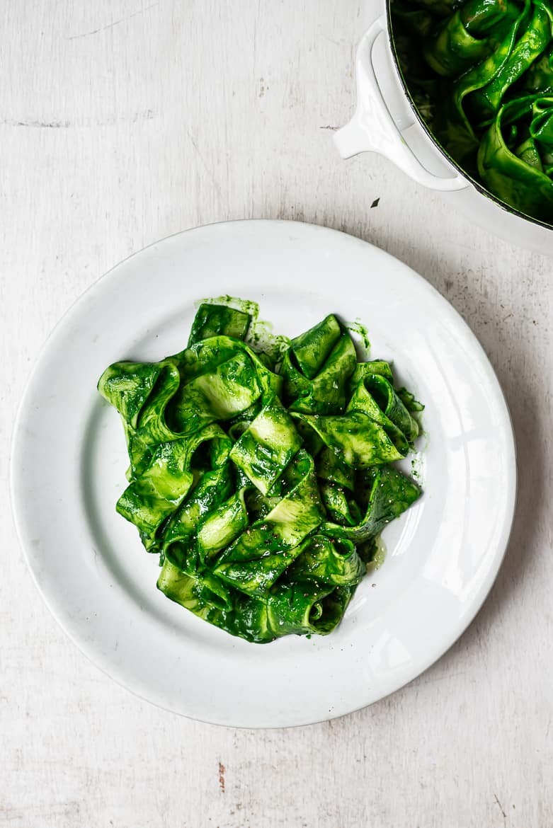 Pappardelle pasta with kale sauce being served