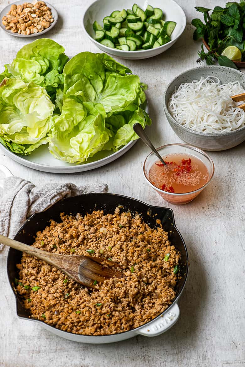 Fixings for the wraps; Chicken filling, rice noodles, lettuce leaves, Nuoc cham, cashews and cucumbers 