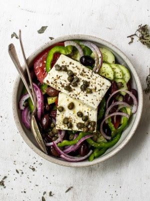 Greek salad topped with slabs of feta