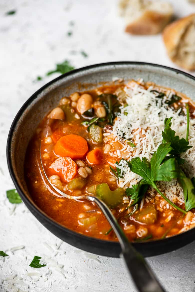 close up of barley minestrone soup in bowl