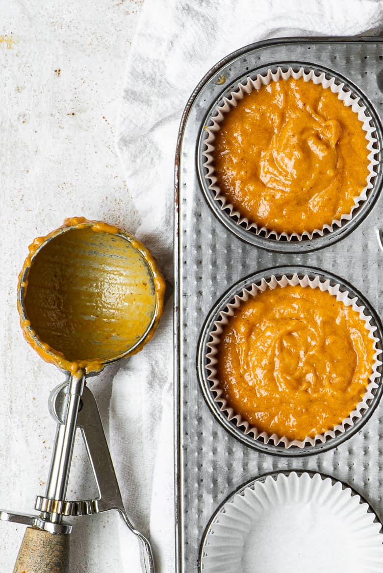 Filling muffin tray with pumpkin mix