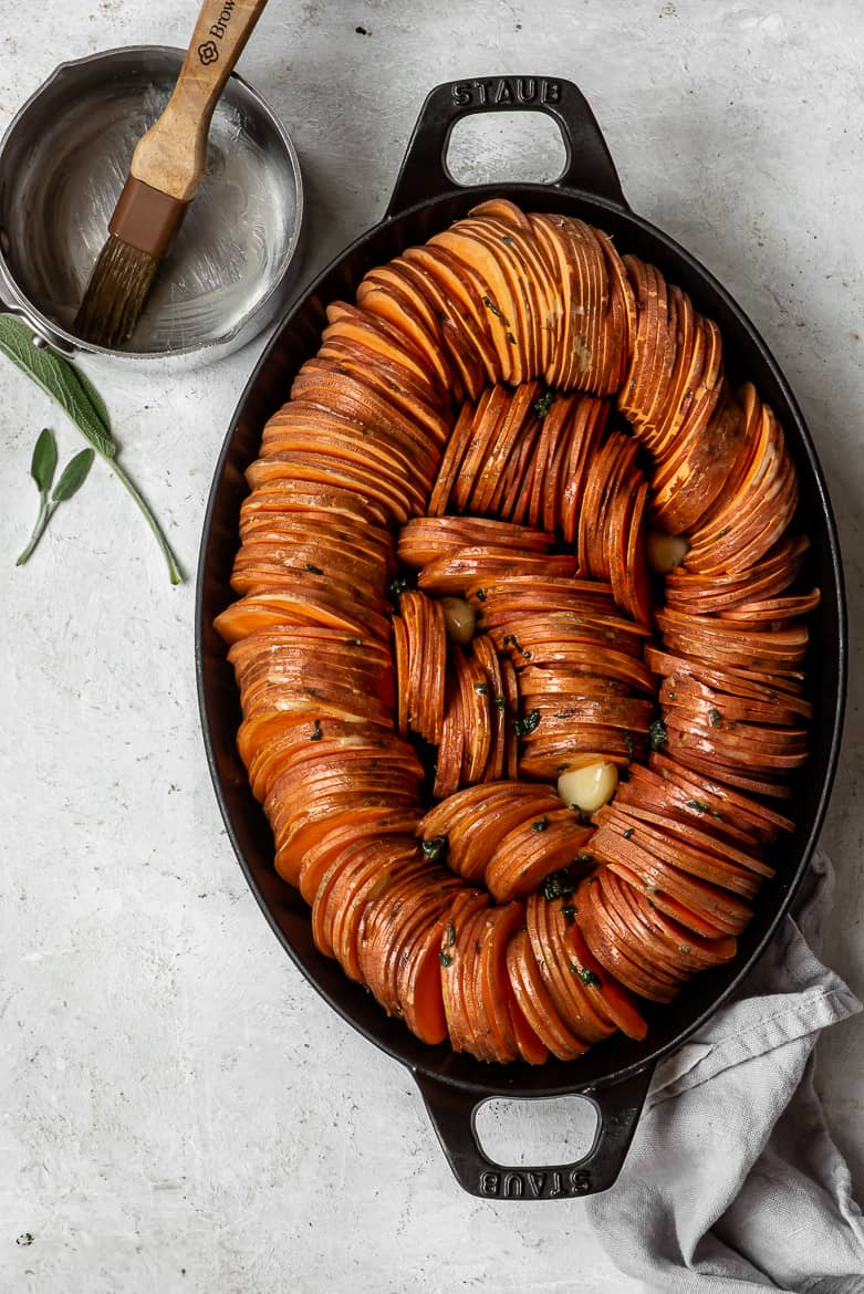 Sweet potatoes slices arranged in casserole dish
