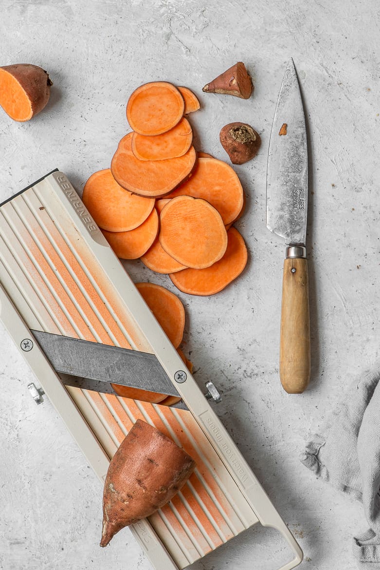 Slicing sweet potato with mandolin