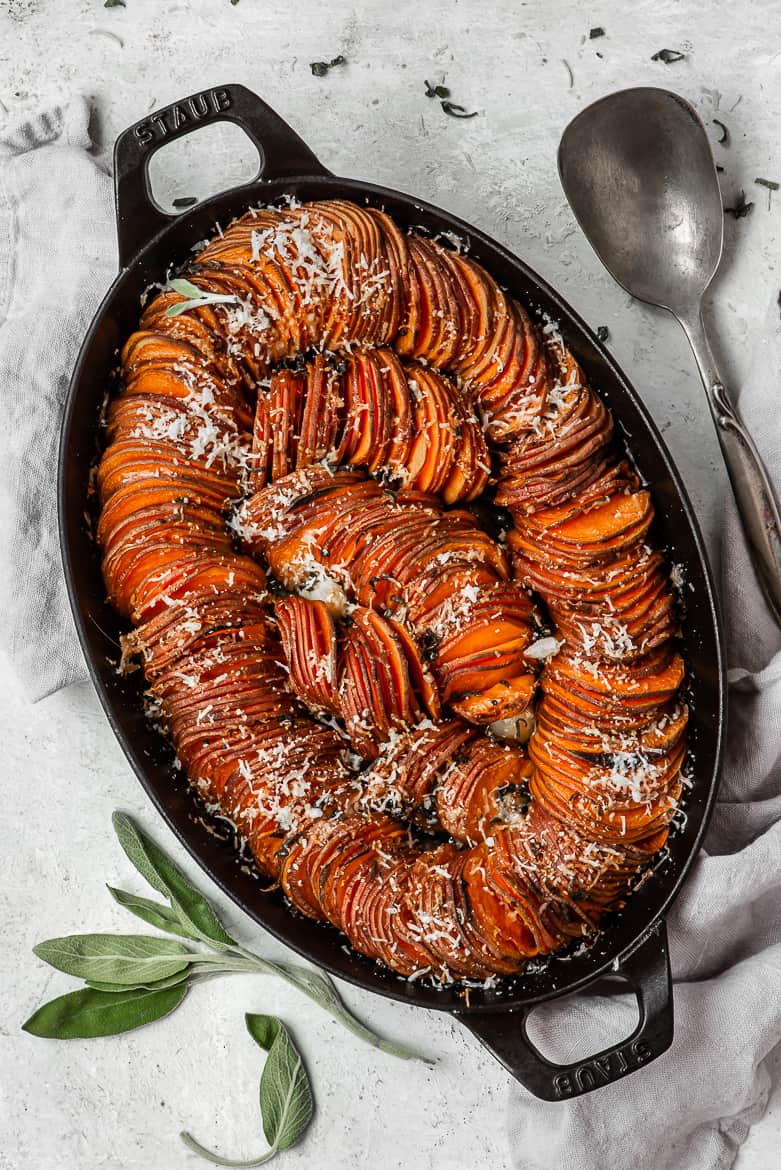 Sweet potatoes gratin with sage in casserole dish