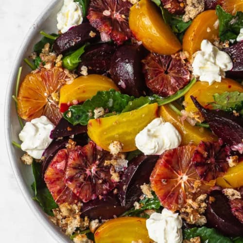 Close up of beets, blood orange, baby kale, ricotta, pangrattato salad