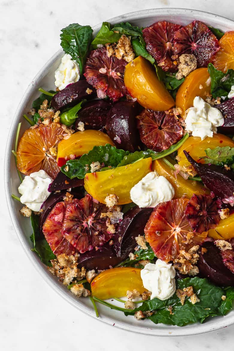 Close up of beets, blood orange, baby kale, ricotta, pangrattato salad