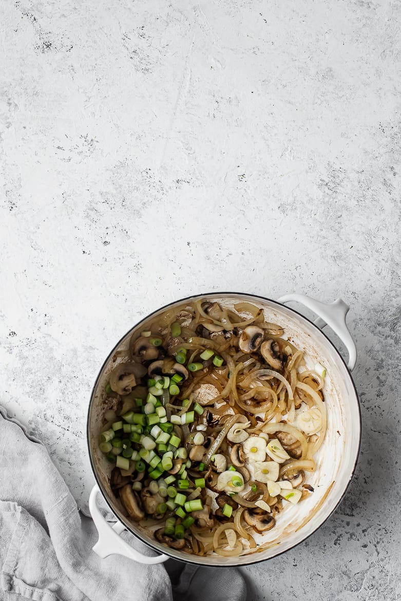 onions, mushrooms and aromatics in pot 