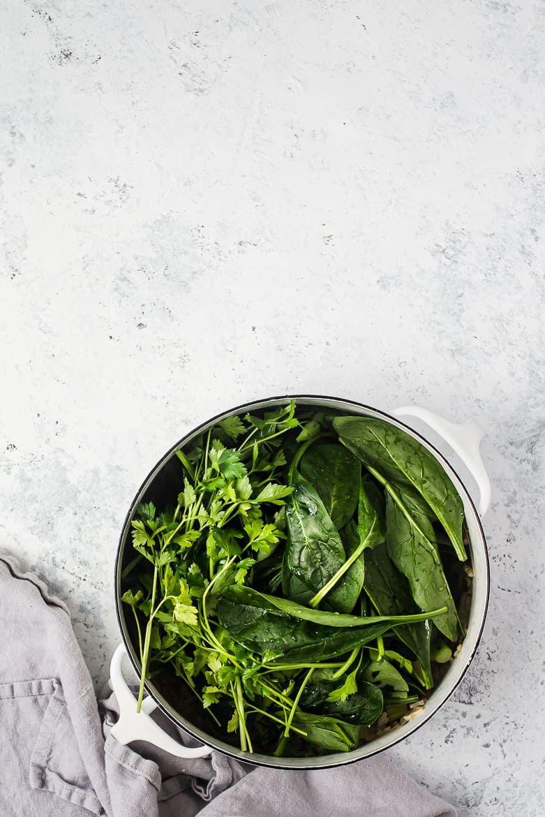 spinach greens added to pot for green soup