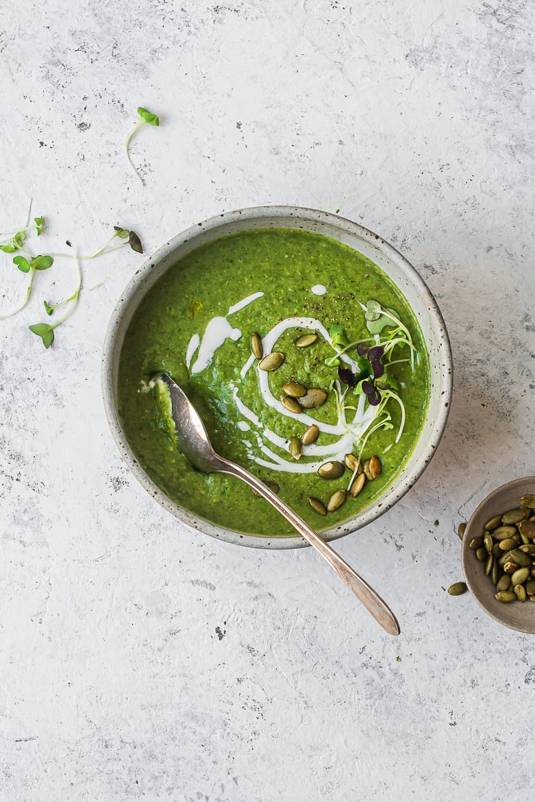 super green soup in bowl with pepitas