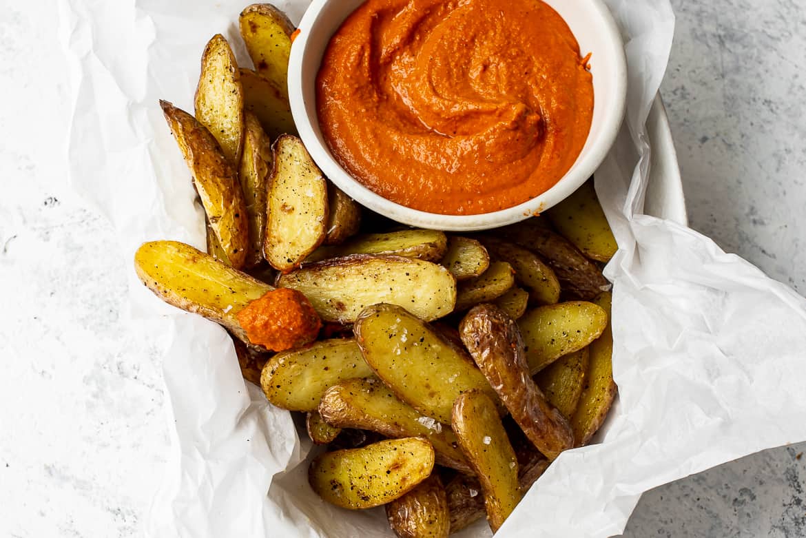 close up of roasted fingerling potatoes with romesco sauce