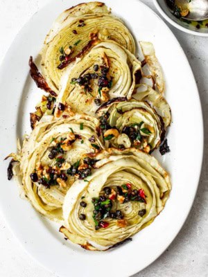 Roasted cabbage steaks topped with walnut salsa