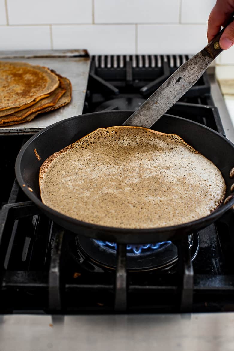 crepe being lifted in skillet