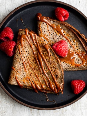 Close up of buckwheat crepes with drizzled dulce de leche