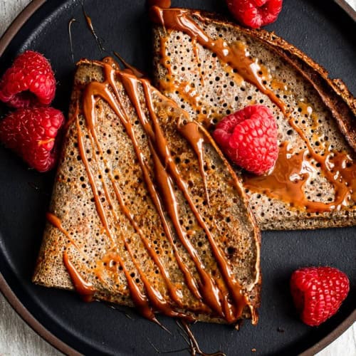 Close up of buckwheat crepes with drizzled dulce de leche