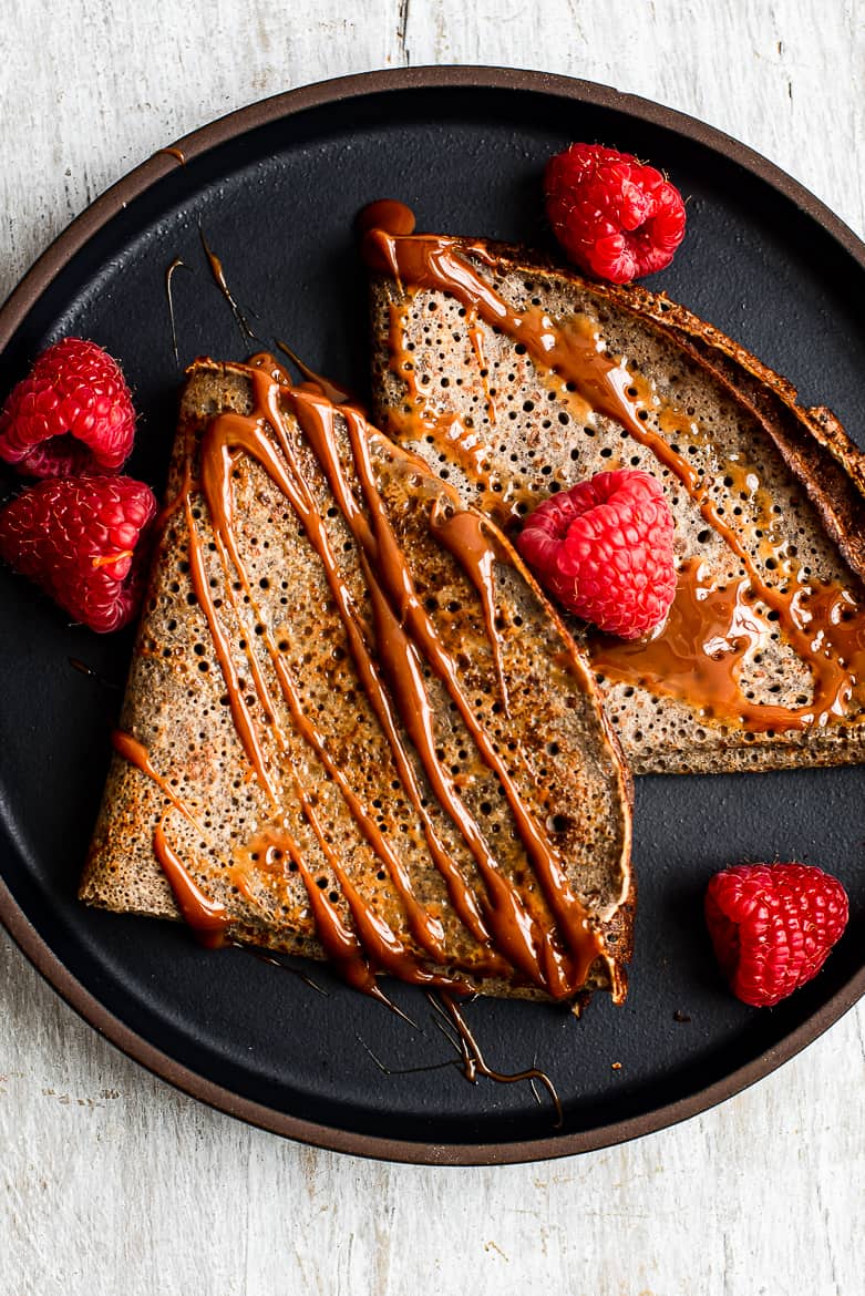 Close up of buckwheat crepes with drizzled dulce de leche