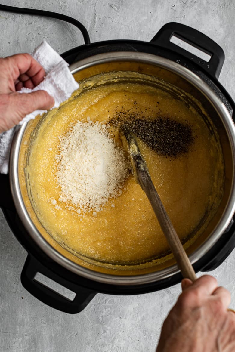 whisking polenta with parmesan and pepper