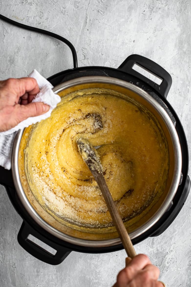 whisking polenta with parmesan and pepper