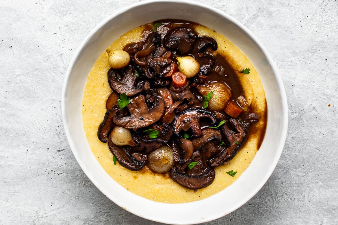 Mushroom Bourguignon in bowl served over creamy polenta