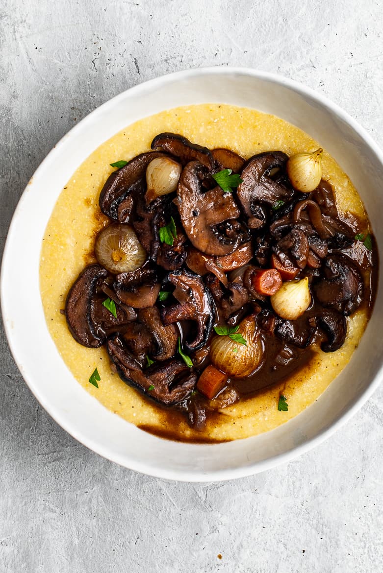 Mushroom Bourguignon in bowl served over creamy polenta