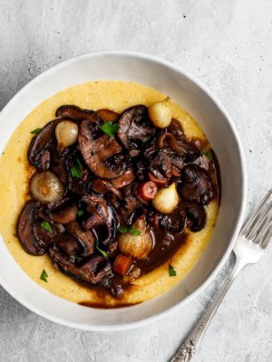 Mushroom Bourguignon in bowl served over creamy polenta