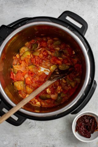 onions, tomatoes and tomatillos sautéing in Instant pot