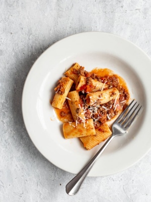 Bolognese with rigatoni pasta in bowl