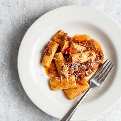 Bolognese with rigatoni pasta in bowl