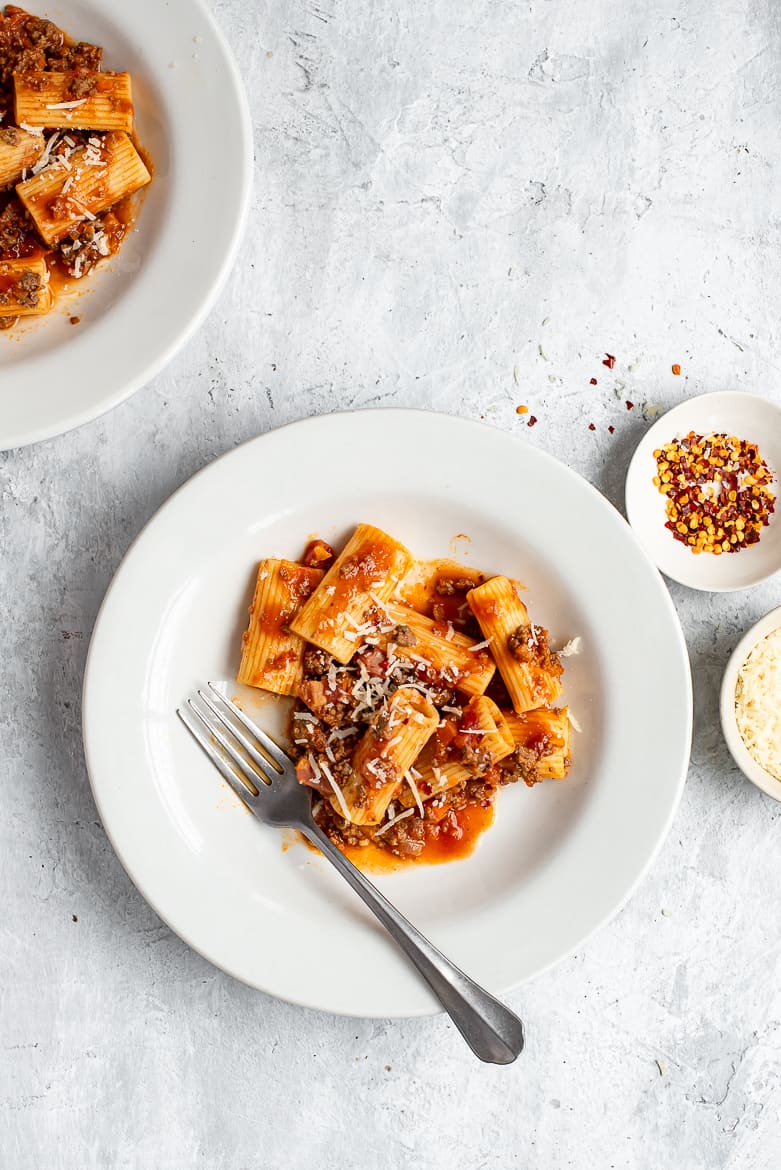 Two bowls of Bolognese with rigatoni pasta 