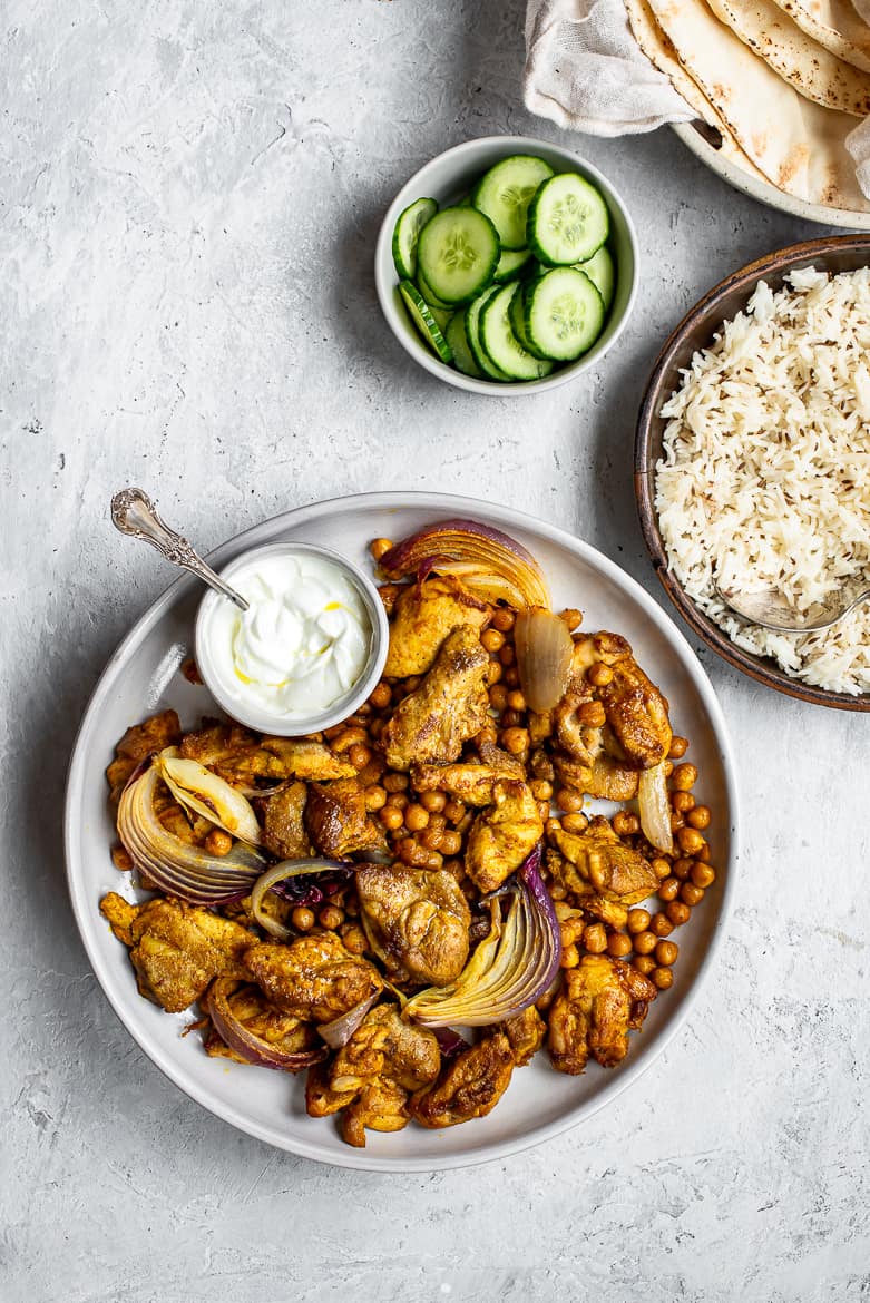  cooked shawarma chicken chickpeas with rice and pita on the side