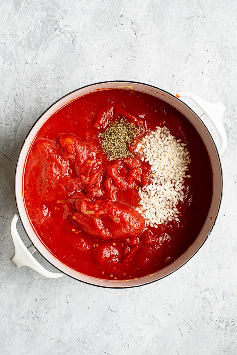 Tomatoes and rice cooking in pot