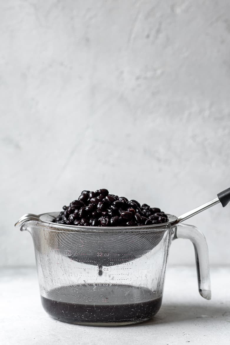 Draining the black beans in a sieve