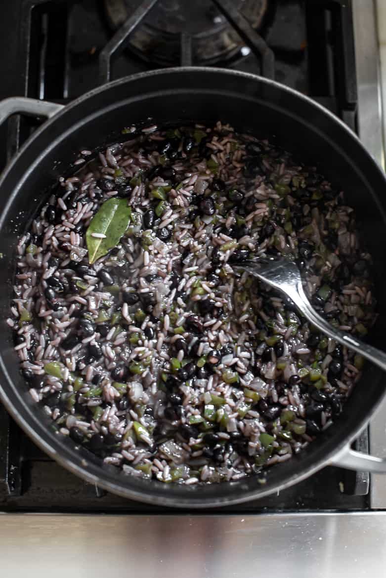 fluffing rice and beans with fork before covering