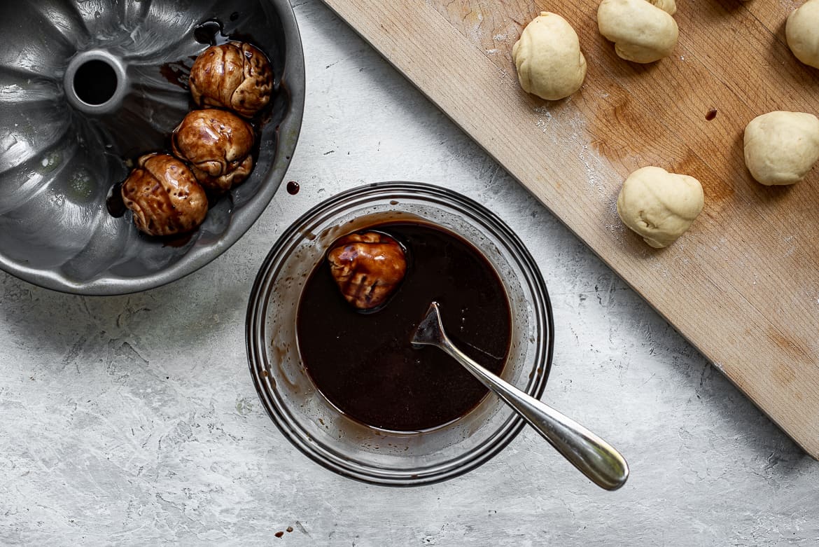 rolling dough balls in chocolate sauce