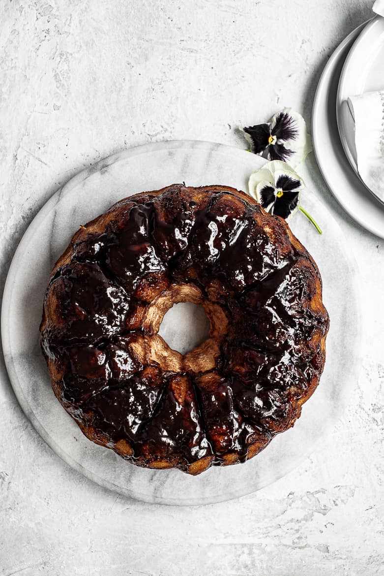 Chocolate monkey bread on platter with plates for serving