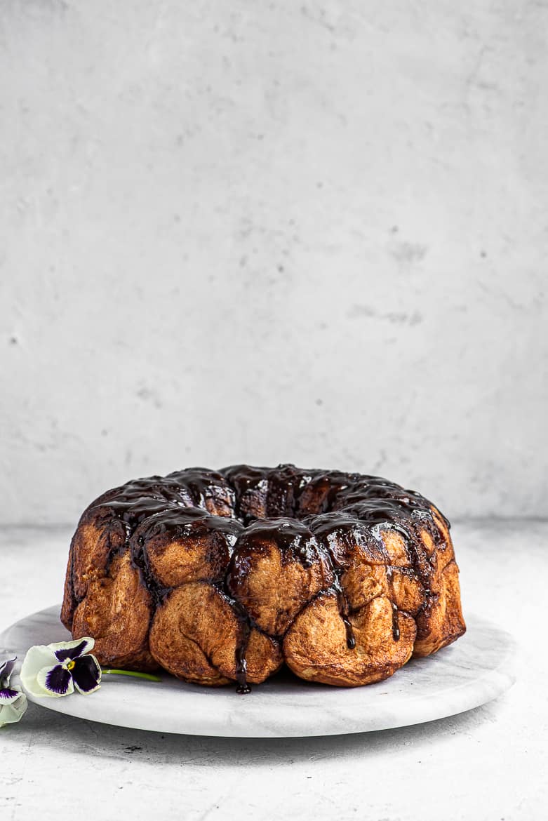 Side view of Chocolate monkey bread on platter with pansies